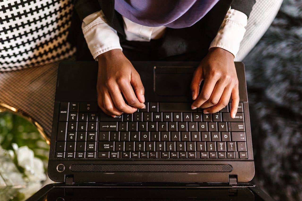 Hands working on a laptop keyboard during a digital project workflow